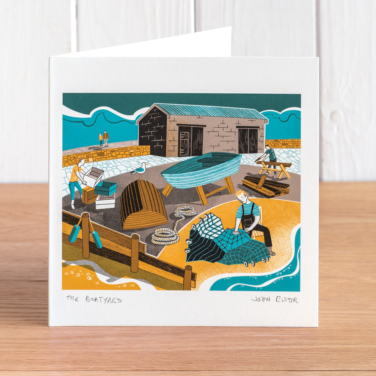 The Boatyard greetings card showing fishermen working on boats and nets.