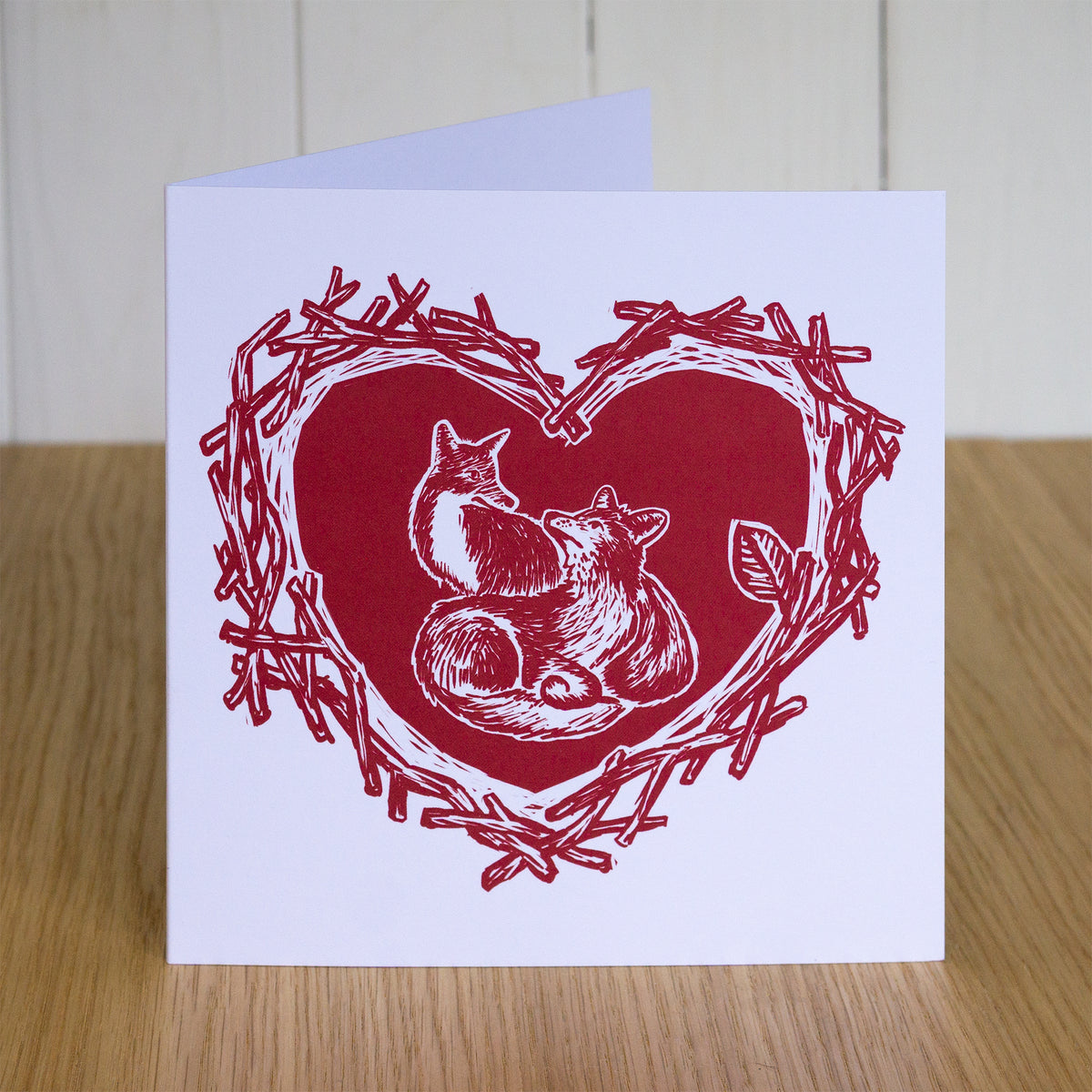 Foxes Valentines card. It depicts two foxes very much in love, drawn in my "digital linocut" illustration style.