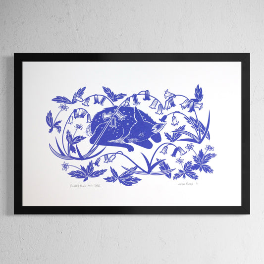 Bluebells and Deer hand pulled screenprint. It depicts a young fawn sleeping amongst bluebells. Shown in a black frame.