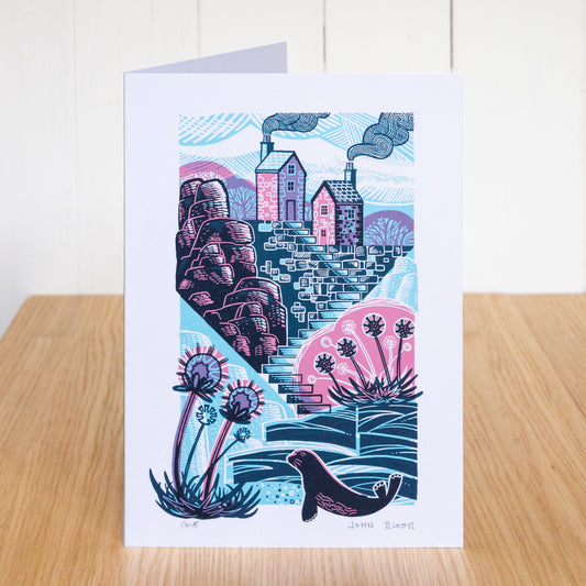 Cove card. It depicts a quiet cove, with steps leading down to it. At the top of the steps are two houses. 