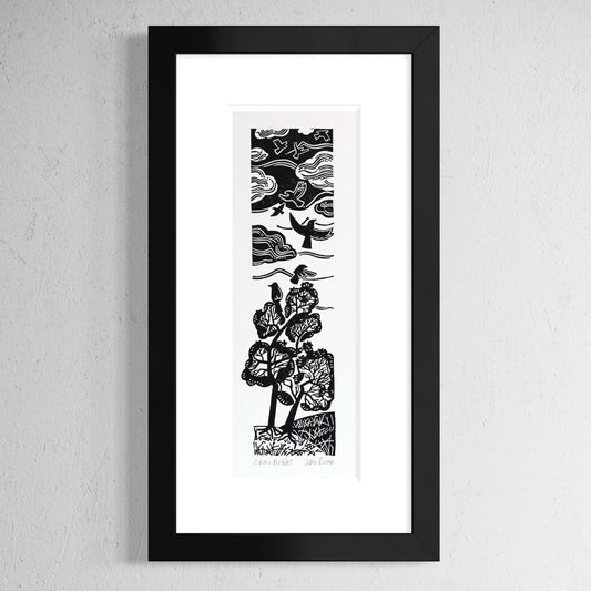 Crow Flight linocut print depicting crows taking flight from trees, flying up into a stormy sky. Shown in a black frame.
