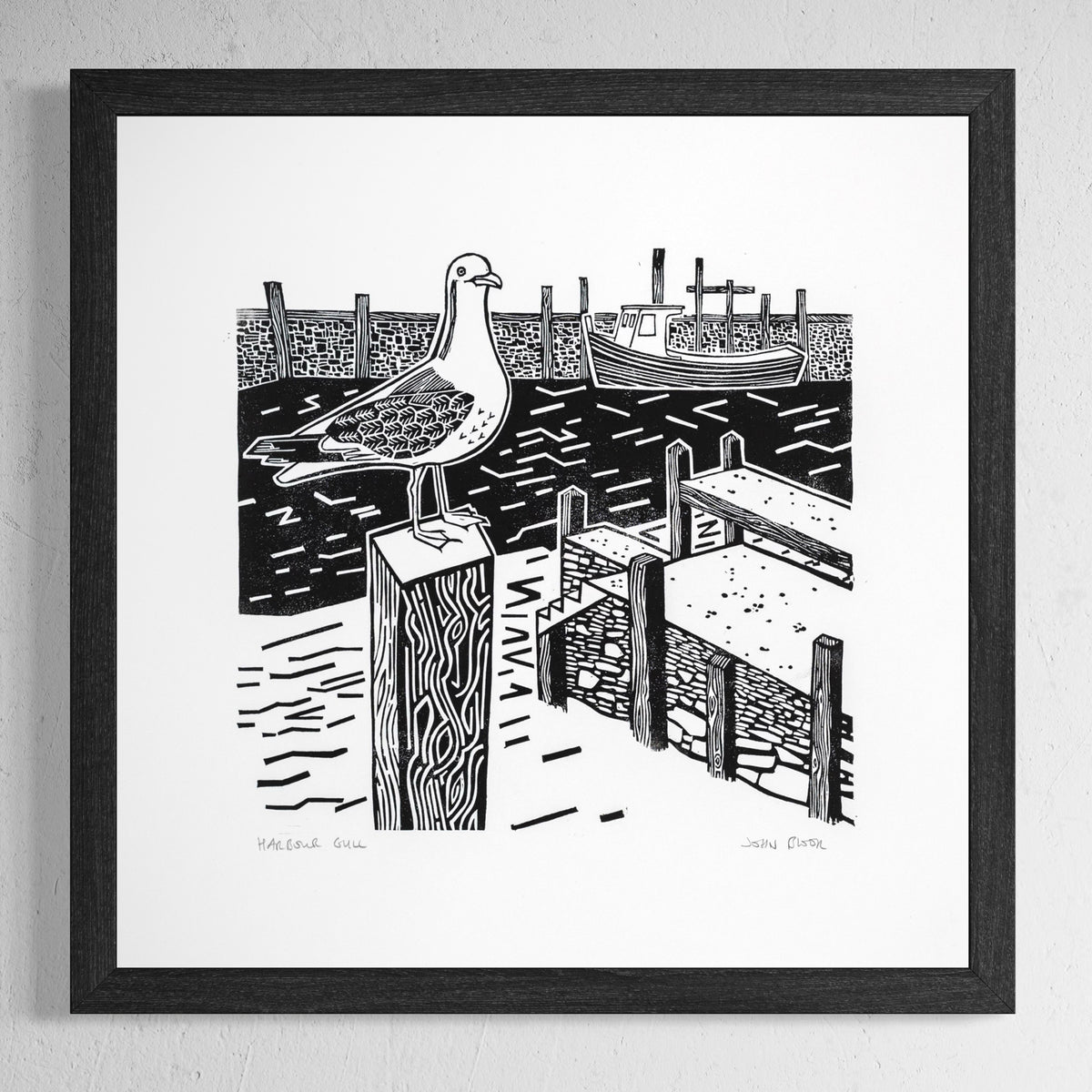 This "Harbour Gull" linocut print depicts a view of a gull on a post in a harbour with the harbour wall and boat behind. 