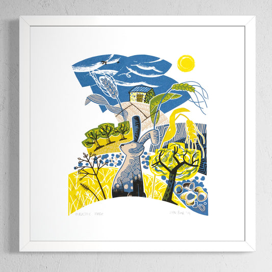 Majestic Hare screen print. It depicts a hare sitting in a yellow field with seed heads, trees, pebbles and a barn. 