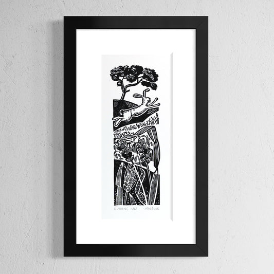 Running Hare hand printed linocut print. It depicts a hare running across vertical fields of wheat which get closer towards the bottom. At the top is a tree. 