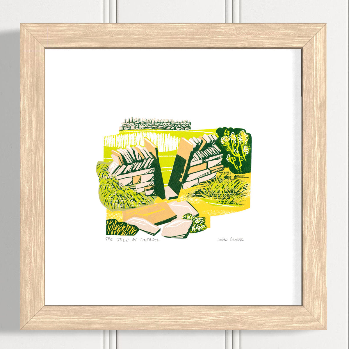 This "The Stile at Tintagel" hand pulled screen print is a small print depicting a stone squeeze stile in a dry stone wall. There is a field behind with another dry stone wall.  Shown in an oak frame.