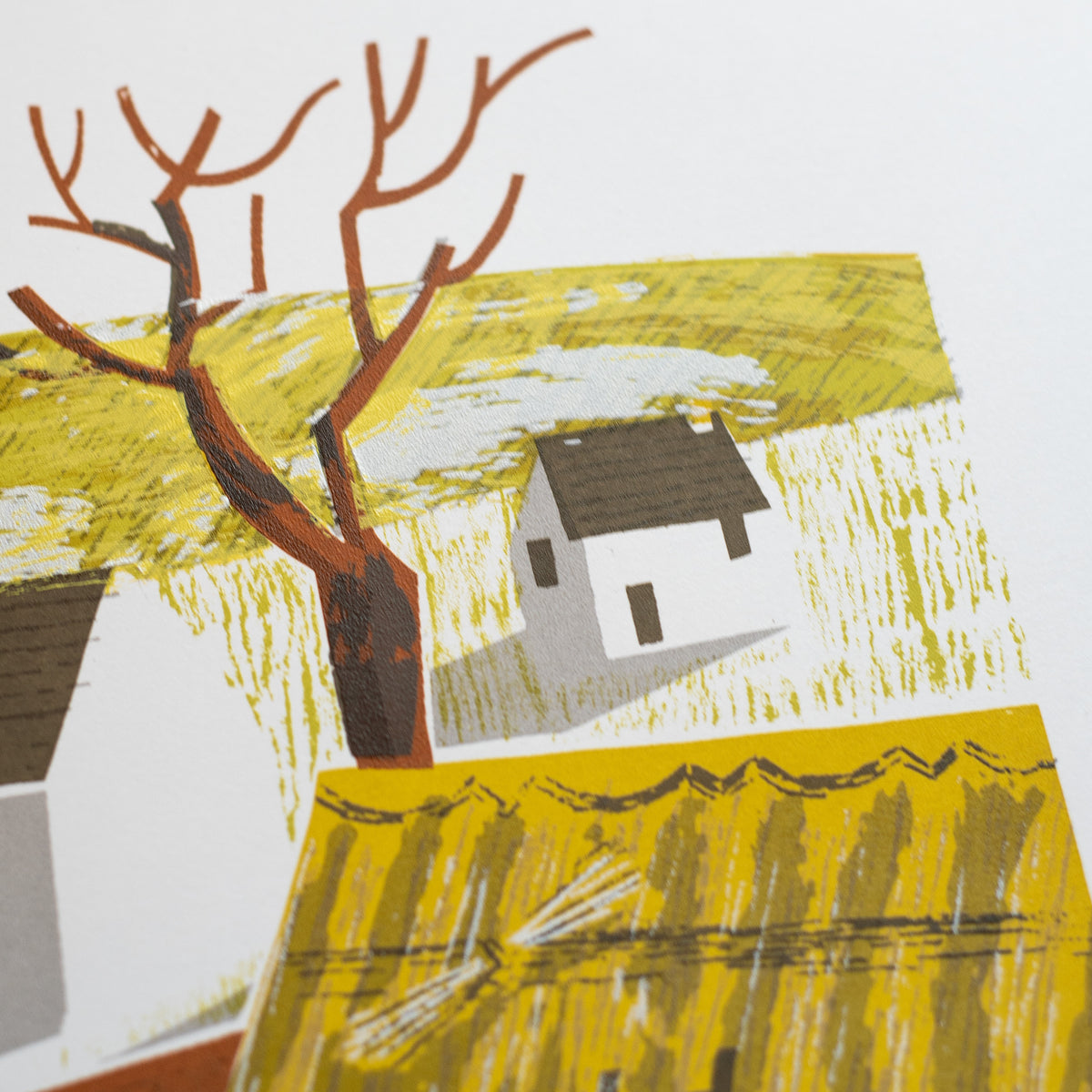 A detail of a screenprint showing a little white cottage and tree.