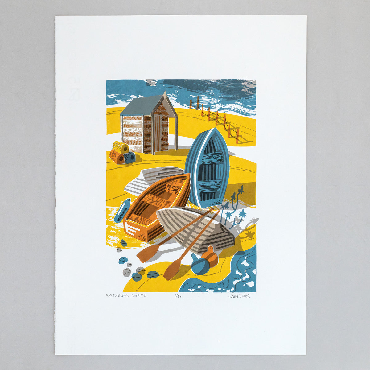 Upturned Boats screenprint, depicting four small wooden boats on a beach, some upturned, with a hut behind that, buoys and a fence.