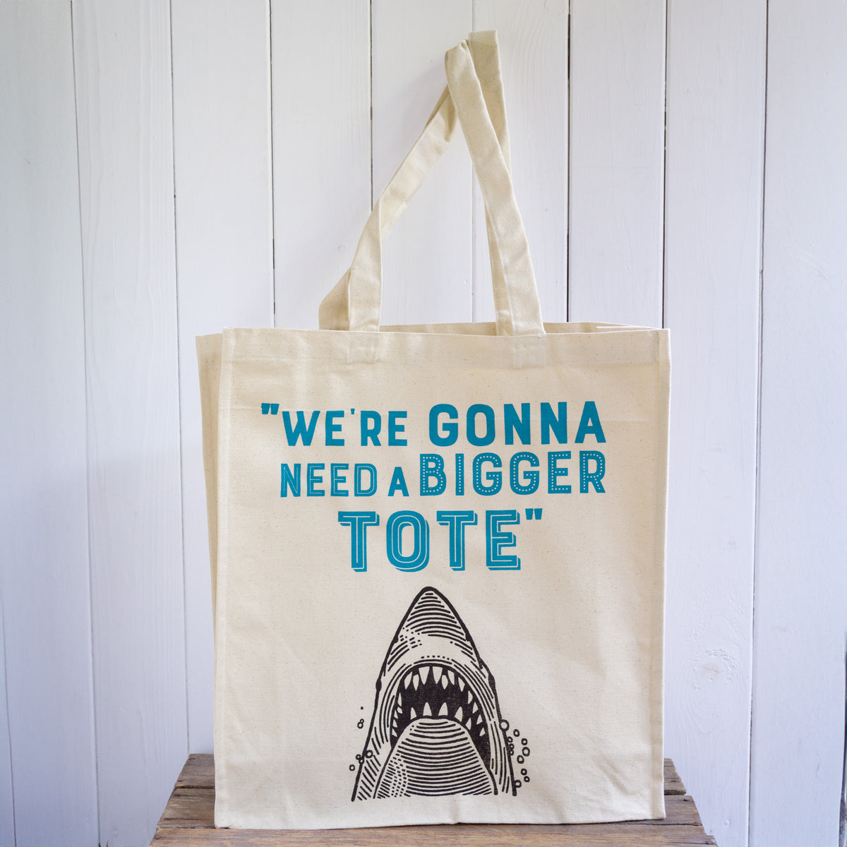 A high quality canvas shopper bag featuring a shark design and the words We're Gonna Need a Bigger Tote.
