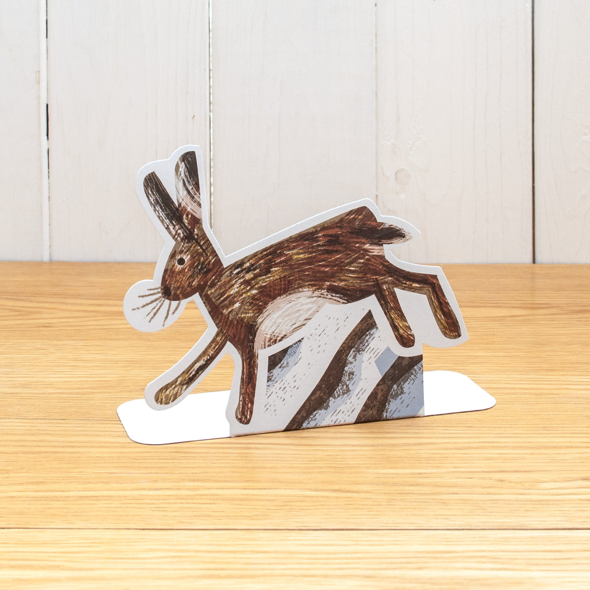 A die cut Hare running, made with natural media marks. It is made of cardboard and stands up.