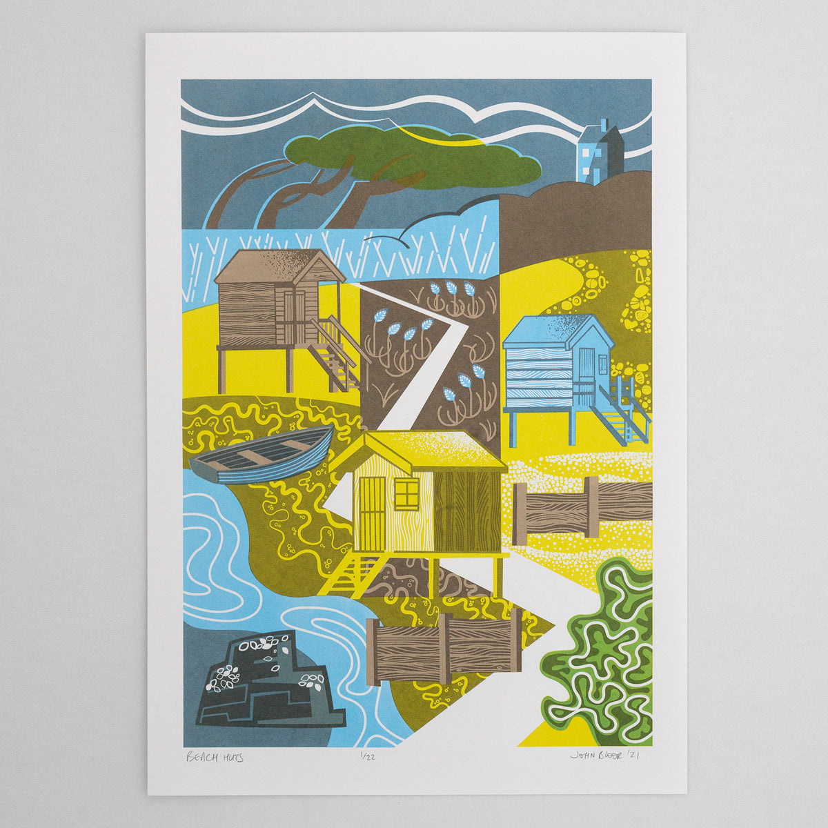 Beach Huts screenprint. The print depicts three beach huts with steps down to the beach, a windswept tree, groynes, sea foam, mussels on a rock and sea kale. 
