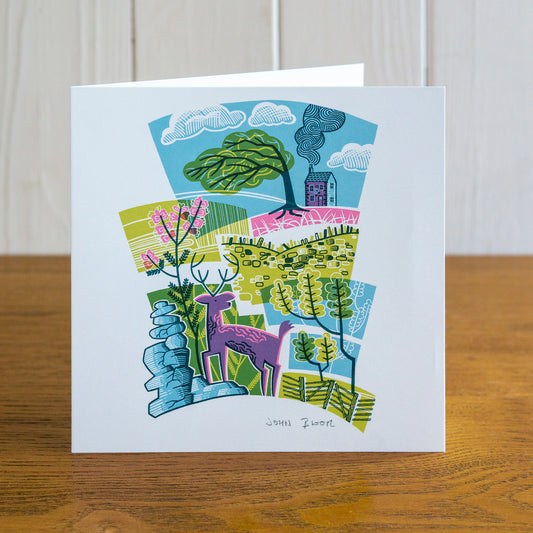 Majestic Animals Stag card. It depicts a stag standing on rocks, with heather, gorse, tree and house behind. Blank inside. 