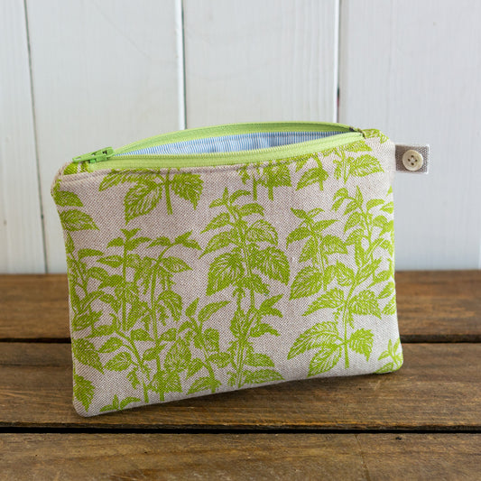 A medium purse perfect for carrying credit cards, a smartphone, cash, & small items, made from my screen printed linen with a nettles design. 