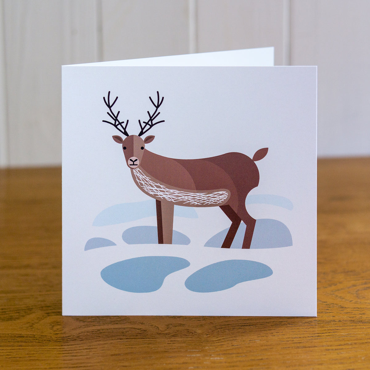 Reindeer Christmas card which depicts a reindeer standing in the snow.