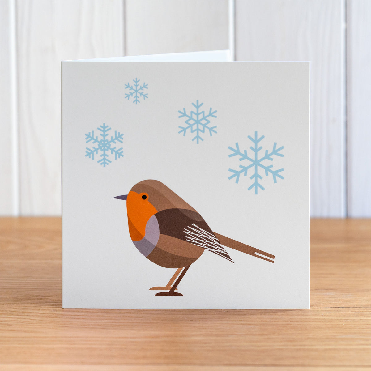 Robin Christmas card depicting a robin with snow falling.