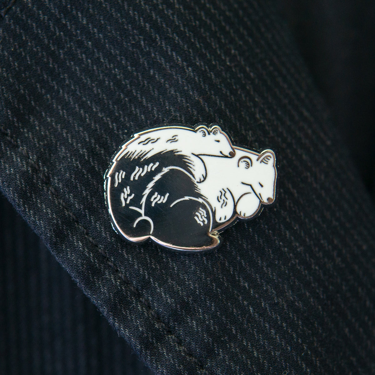 Sleeping Bears hard enamel pin shown on a blue coat.