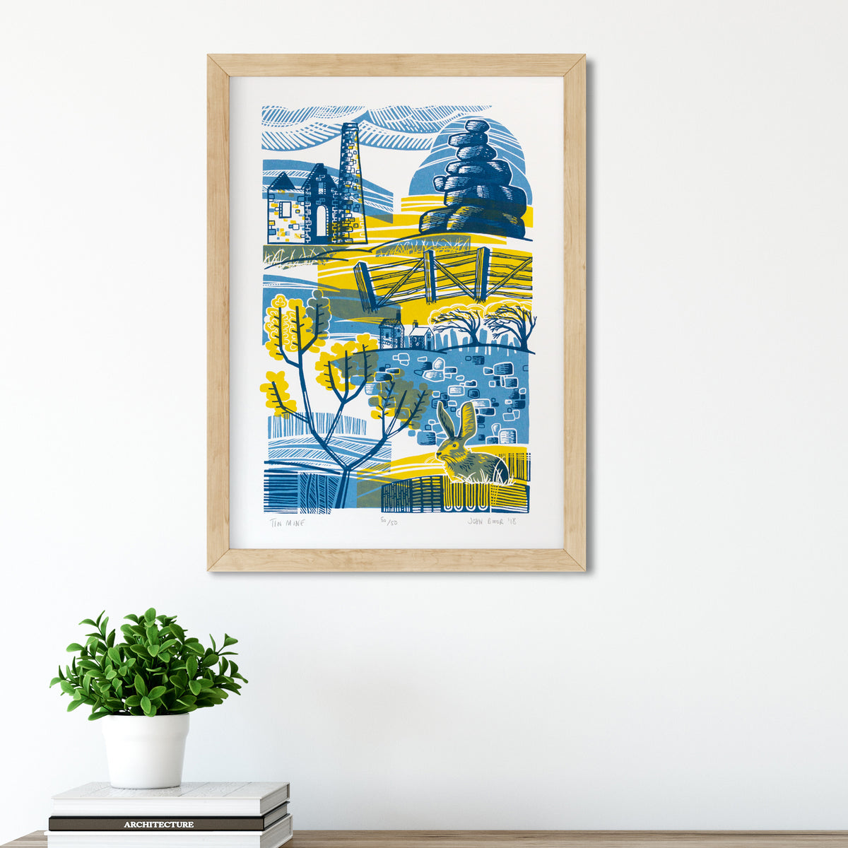 Tin Mine screenprint. It depicts a tin mine in an abstract scene, with a rock stack, fence, gorse, a rabbit, dry stone wall, houses and wind blown trees. 