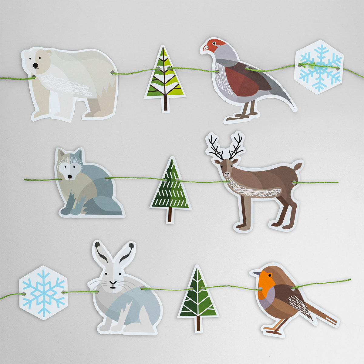 This garland is made of six Winter animals, two snowflakes and three fir trees. It features polar bear, partridge, Arctic fox, reindeer, Arctic hare and robin. 