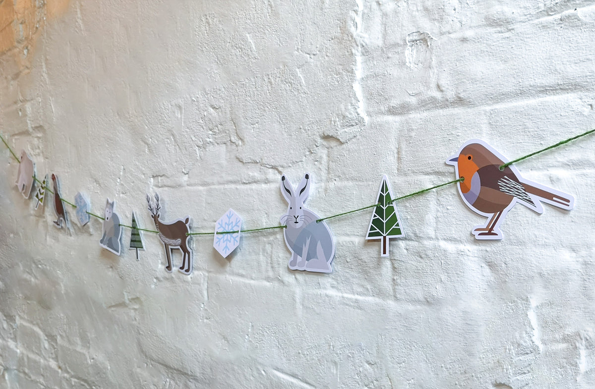 This garland is made of six Winter animals, two snowflakes and three fir trees. It features polar bear, partridge, Arctic fox, reindeer, Arctic hare and robin. 